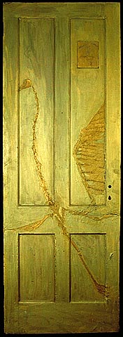 relief of two birds one a skeleton in gold encaustic on door